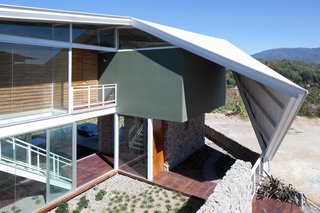 Striking Green House with a View in El Salvador - Photo 3 of 7 - Triangular sails fold over the portions that receive the harshest sunlight.