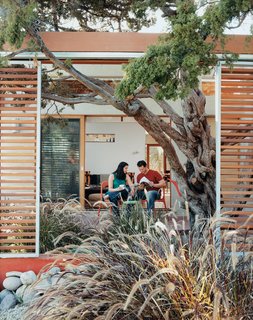 Casa Study House #1 - Photo 5 of 10 - The layering of the remodeled house is revealed in this image of Robin and Jeremy relaxing on the front deck.