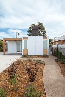 An Innovative Net-Zero Prefab in Los Angeles - Photo 1 of 3 - Components for low-cost prefab homes designed by Habitat for Humanity and the firm Minarc for South Central Los Angeles were trucked in and assembled over three days. Photos by Art Gray.