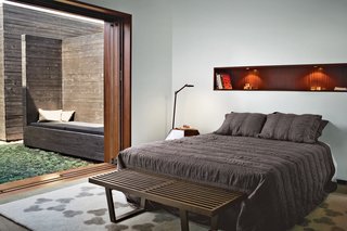 The master bedroom leads to its own private courtyard. The rug is from Peace Industry; the Kelvin LED floor lamp for Flos is from Lumens. Photo by Coral von Zumwalt.