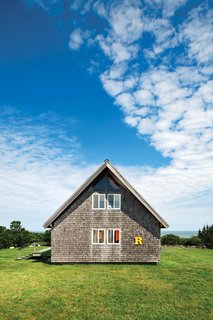 Jens Risom's Block Island Family Retreat - Photo 12 of 13 - A bright-yellow "R" sign, from a truck that used to deliver furniture from Jens Risom Design, sets off the southern facade. When Jens designed the house, he stipulated that he wanted cedar shingles, not the asphalt ones that came with the original design from the catalog.