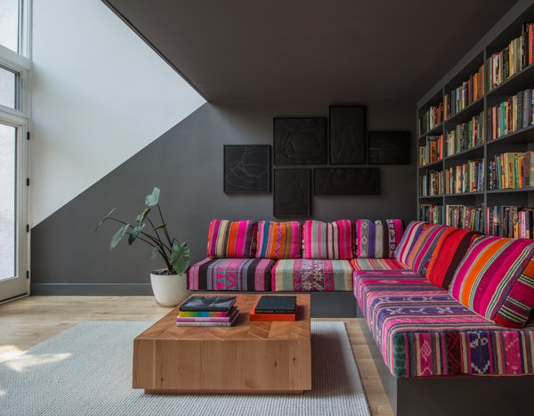 In the basement lounge area under the stairs, Lee had a giant sofa is upholstered in 18 Peruvian blankets that JHID collected over several months. The paintings are by Heather Watkins, a Portland artist. The coffee table is custom design in solid fir, which adds a lighter counterpoint to the Benjamin Moore Kendall Charcoal paint used in the alcove. Photo 4 of Color Splash modern home