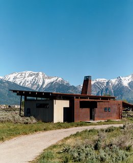 Eric Logan's guest house is adjacent to his family’s home. The interiors are made up of oiled masonite wall paneling, raw MDF cabinetry, and an oiled concrete floor.