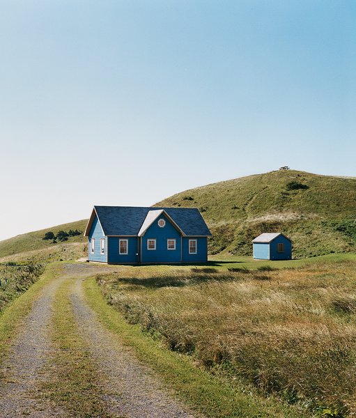 A small deck off the back of the main house is protected from the wind and supported by a small grassy mound.