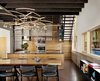 “We wanted to bring the outside in with the warmth of the materials,” Flato says. “A custom dining table and shelving were designed and built from a pecan tree that had fallen on the site.” Vertical grain Western red cedar, the same material used for the exterior siding, was also used to create custom kitchen cabinets. Photo 3 of Hog Pen Creek modern home