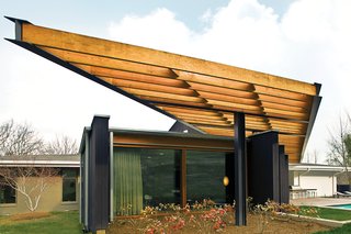 The Trellis That Keeps It Cool - Photo 1 of 2 - The house incorporates a variety of wood finishes, all in the same general color palette: unfinished ipe for the pool terrace, Douglas fir for the trellis and windows, and stained cypress for the siding mixed in with the exterior’s original redwood.