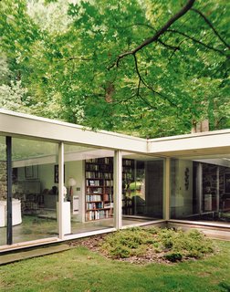 The courtyard captures nature within the embrace of the house, a "room" of green that is simultaneously indoors and outdoors.