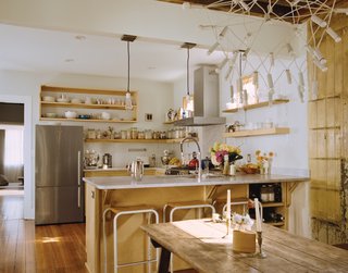 The trio of pendant lamps hanging above the counter came from Schoolhouse Electric Co. and were reworked by Peyton Avrett to fit the width of the header beam to which they are attached. The bar stools were gifted from a friend.