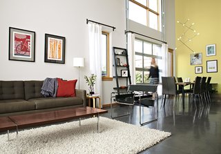 Cost-Effective Family Home in Pittsburgh - Photo 3 of 8 - The living area features a Petrie sofa from Crate & Barrel and a Wassily chair by Marcel Breuer from Knoll. A vintage walnut coffee table by Lane Furniture sits atop a rug that the couple purchased at Weisshouse, a Pittsburgh home-furnishings store.