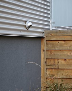 Cost-Effective Family Home in Pittsburgh - Photo 7 of 8 - "The use of corrugated metal "was a very cost-effective cladding solution that pays homage to the metal-clad warehouse buildings in Lawrenceville," Moss says, "but it does so in a manner that matches the scale of most of the lap-siding homes in the area." The windows are mostly standard sizes from Pella.