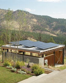 The Solar Revolution installed 3.6-kilowatt photovoltaic solar panels on top of the carport, which sports a board-formed concrete exterior and a cedar-slat-and-plywood interior.