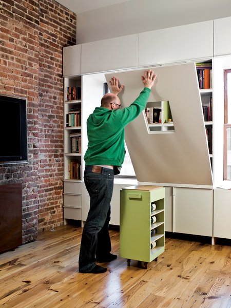 In the living room, a sizable table disappears into vertical space to make room for parties or playtime with the kids.