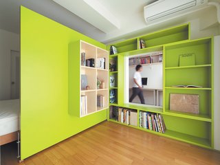 Shibata wanted more shelf space in her home office, so she added a plywood door with built-in bookshelves that opens into her bedroom to form a reading nook. Glimpsed from the adjacent room, the space looks larger than it actually is, thanks to the bright green walls.