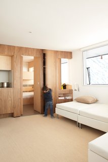 8 Modern Paneled Rooms - Photo 7 of 8 - Built-ins abound in this renovation of a 1970s lodge perched high in the French Alps. H2O Architectes devised a plan to increase livable space while leaving the structure intact. Panels slide open to connect the spaces, or closed for privacy.