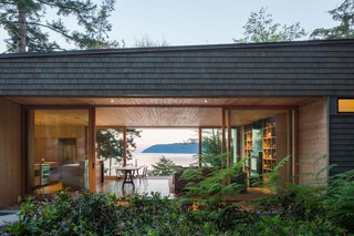 Our Daydream of Living on an Untouched Island Comes True in Washington - Photo 3 of 8 - "The home is quite small, but designed in such a way that you don’t feel it," Herrin says. Lift-slide openings by Quantum Windows & Doors, which were fabricated fewer than 50 miles from the house, make the main living space seem larger.