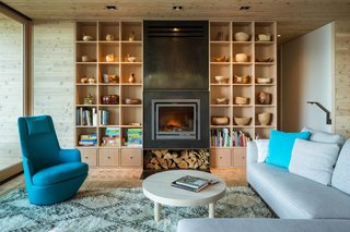 Our Daydream of Living on an Untouched Island Comes True in Washington - Photo 4 of 8 - A sofa from Design Within Reach opposes a Hi Turn chair by Bensen in the living room.