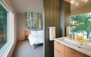 Our Daydream of Living on an Untouched Island Comes True in Washington - Photo 5 of 8 - A Design Within Reach bed is steps away from a Second Floor sink by Duravit that’s outfitted with an Essence Grohe faucet. Benjamin Moore’s Templeton Gray is painted on the master bathroom’s wood paneling.