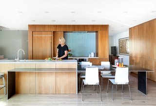 Hawkins removed walls and swapped outdated storage for floor-to-ceiling African mahogany cabinetry.