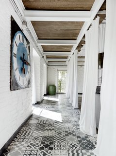 A carpet of custom tile created by Navone punctuates a corridor on the first floor.