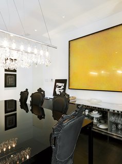 A Traditional Home and an Impeccable Eye - Photo 1 of 8 - The dining room’s high drama is thanks to a Cellula chandelier by Nunzia Carbone and Tiziano Vudafieri, a sleek Colors table by B. Fattorini for MDF Italia, and a massive yellow painting on <br><br>the wall by Polish artist Pitor Uklański.