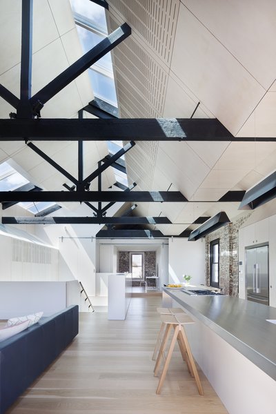 “The fact that the external walls were built to the site’s boundary led to the solution of skylights as the one of the few means of introducing north light and good cross ventilation into the building,” Simpson continues. The hanging lights are from Artemide while the hotplates and cooktops are from Barazza. Photo 3 of Water Factory modern home