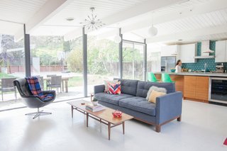 7 Modern Eichler Renovations in California - Photo 2 of 8 - Built by Joseph Eichler, this home was designed by A. Quincy Jones and Frederick Emmons. While bringing the home back to its former glory, this family with two children also made some modern updates. Karen Nepacena and John Shum upgraded the kitchen with an island, which was built in the couple’s backyard, with custom Walnut cabinetry by Semihandmade Doors from IKEA around it.