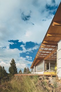 Bohlin Cywinski Jackson’s design for the Verheyden clan is instantly legible from the back deck, where the repetition of trusses, windows, and lumber creates a strong linear profile.