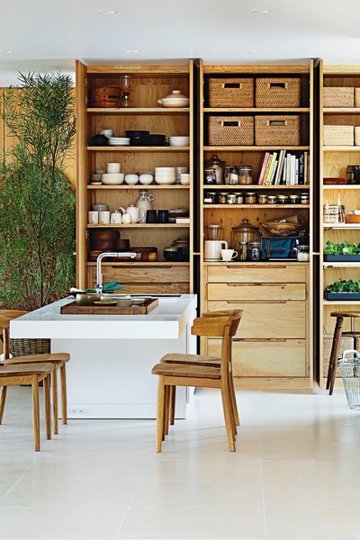Load-bearing elements are clustered together in the form of storage instead of a typical post-and-beam format.