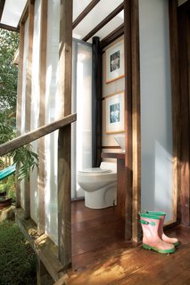 Nearby, the bathroom includes a composting toilet and a Home Depot sink on a pedestal Chris made from chunks of found wood.