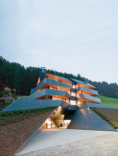 In the Dolomite mountains, an angular copper-clad apartment building echoes the topography of its site. Photos by Hertha Hurnaus