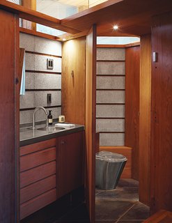 The Midcentury Home That Maintains Its Quirkiness After All These Years - Photo 5 of 9 - The concrete continues in a bathroom, with an MGS faucet and a toilet from Foshan Fuly Bao.
