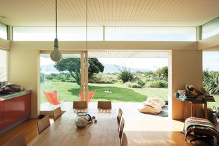 Bach to the Beach - Photo 1 of 30 - The bach’s beachfront site is nestled behind sand dunes with views toward Kapiti Island, a nature sanctuary.