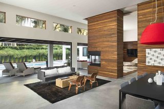 Ipe makes another appearance in the living room, creating a strong indoor-outdoor connection. Kean sited the transom windows to capture views of the moss-covered trees in the backyard.