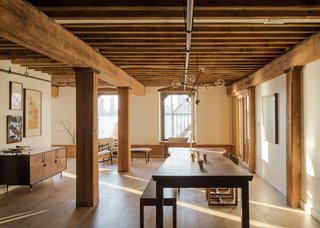 Mark Berryman found a converted 1864 factory building he loved on the western edge of Manhattan’s Tribeca—where he can run along the edge of the Hudson River with his chocolate Lab, Leji, or easily escape to Long Island for a surf trip. He was living in the building when a smaller yet more desirable apartment with sweeping river views became available there in 2013. He bought it that October, even though interior walls awkwardly sliced up the 1,800-square-foot space. Planning a complete gut renovation, Berryman interviewed four design firms before hiring Brooklyn-based Workstead.<br><br>Workstead came back with a plan that included taking down many of the interior partitions, tearing out the drywall ceiling to expose the building’s hefty original fir joists, and painting the existing pipes black. "We wanted to uncover things to celebrate them," says Workstead partner Robert Highsmith. "We wanted to create an interior that connects with the building’s sense of place."