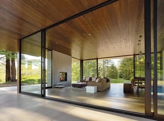 This Couple Achieves Their Glass House Goals - Photo 2 of 5 - "Creating efficient space is valuable, but for us, rooms that offer visual and spatial continuity with nature are also important," architect Julie Dowling explains. "When the sliding doors are open, the living room and kitchen double in size."