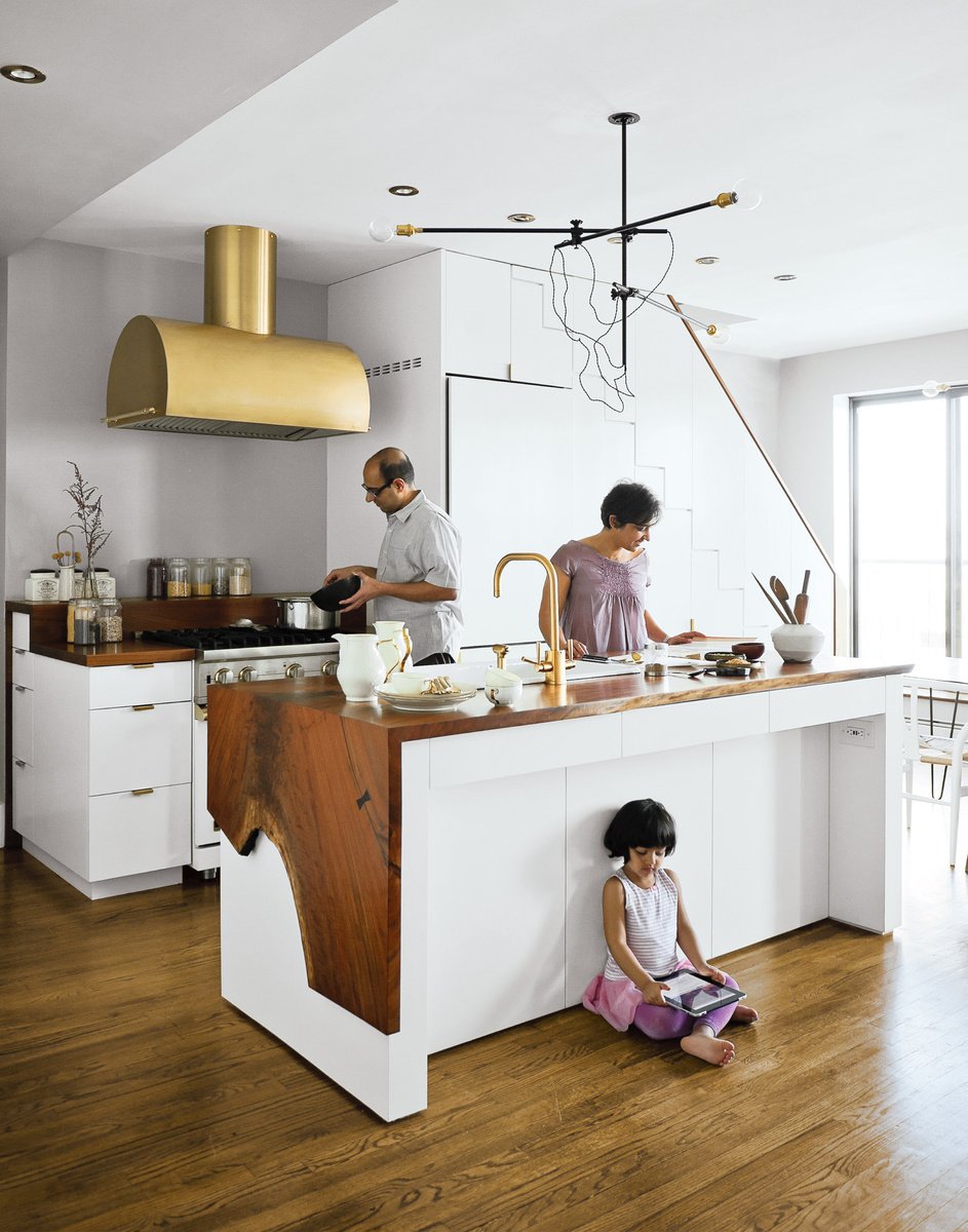 The Mandayam–Vohra family gathers under one of Workstead’s signature three-arm chandeliers, shown here in its horizontal configuration. Photo by: Matthew Williams