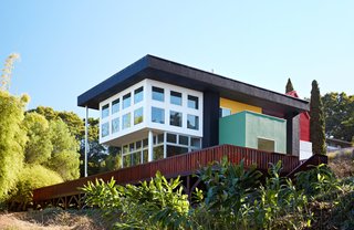 Thank Sottsass for the Most Memphis House Imaginable - Photo 13 of 14 - A large Douglas fir deck coated with Cetol finish from Behr extends into the home’s sloped site.