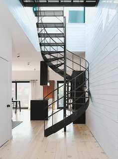 Di Ioia and Bédard designed the wrought-iron spiral staircase that leads to the rooftop terrace and sauna as a visual nod to Montreal’s signature outdoor stairways.