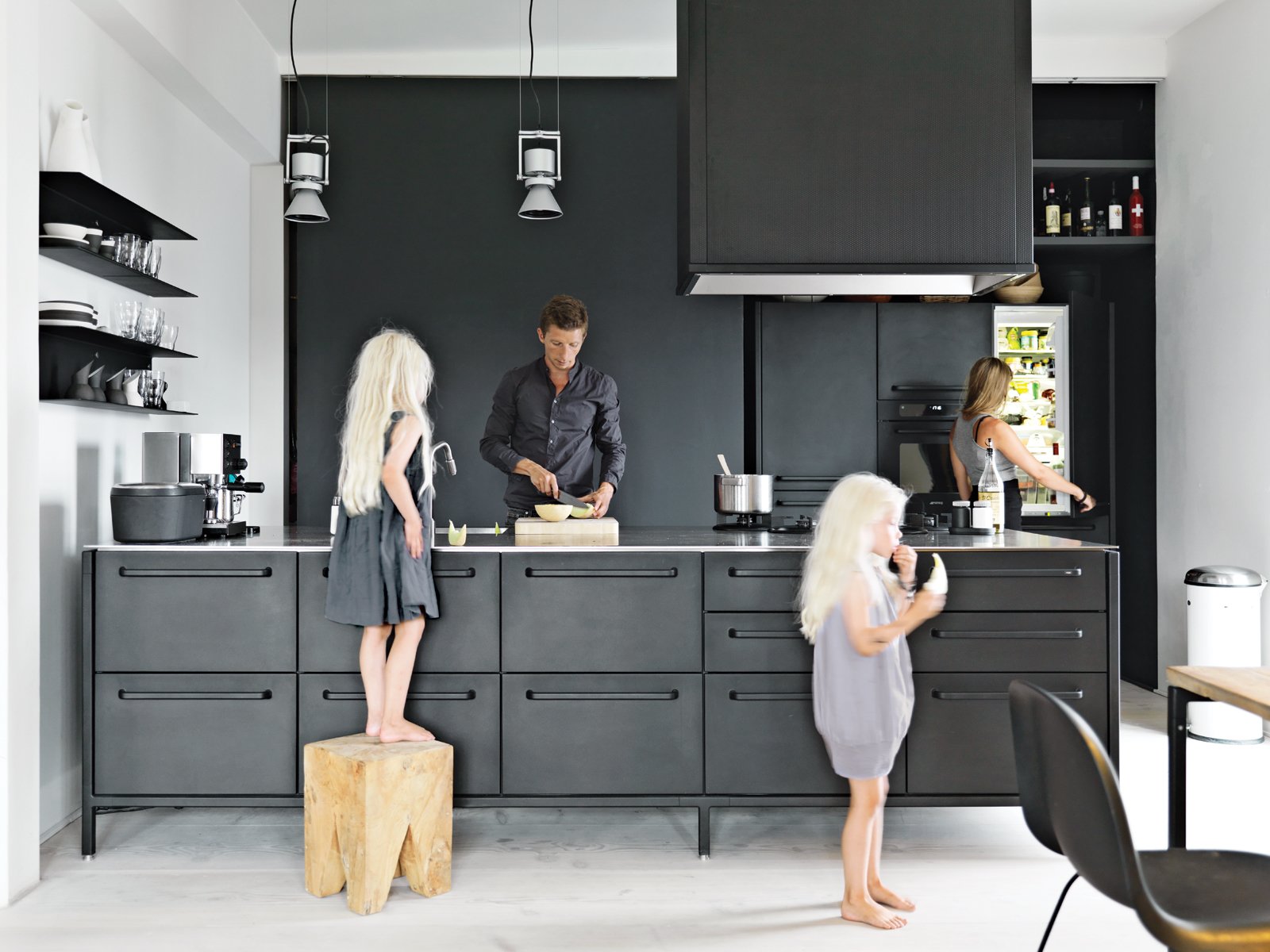 Twin daughters Merle and Anine join their parents in the family’s kitchen, designed by Jensen for Vipp. He explains that his role as chief designer at Vipp is to “work with their DNA” by refining the company’s trademark materials: stainless steel, painted metal, and rubber. For the utilitarian kitchen, “we wanted to get the feeling of a tool,” he says. “It’s nice to have a space where you can actually work.” The gas stovetop is by ABK and the refrigerator is by Smeg; Le Perroquet spotlights are from iGuzzini.