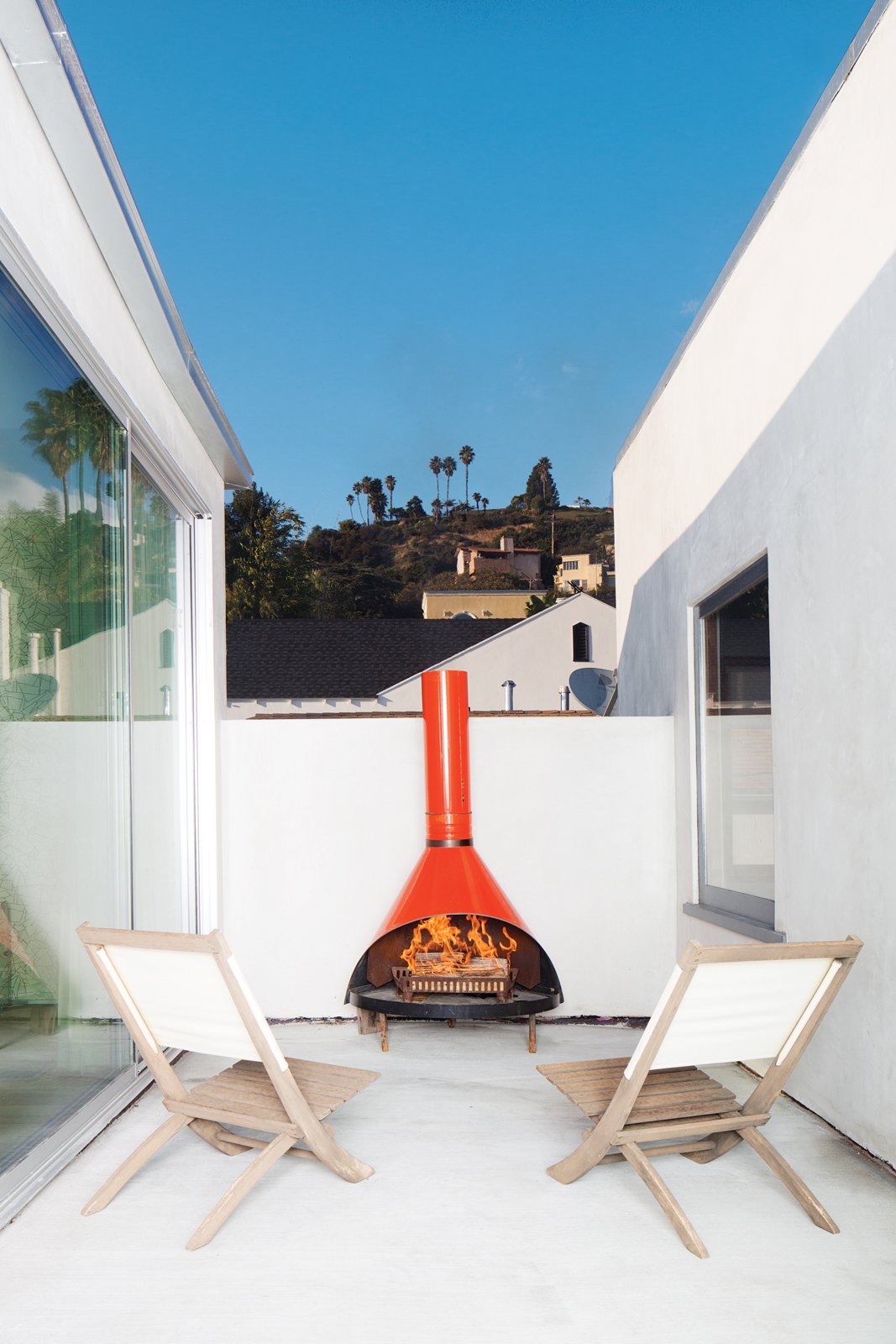 A fireplace found at the Rose Bowl Flea Market furnishes another of the new deck spaces.