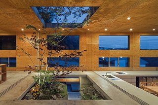 The building is composed of a partially-buried concrete box covered with a well-insulated cedar-and-larch shell (what Maeda calls "the nest" and "the fallen leaves"). 