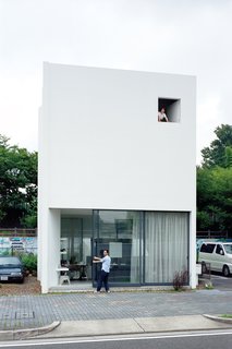 Yurika Ninomiya says good morning to busy central Nagoya from her third-floor bedroom while husband Takuya opens up the shop and gallery that they run below.