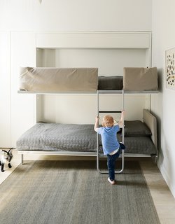 How One Family of Three Does It All in 675 Square Feet - Photo 5 of 14 - The bunk bed, the Lollipop IN model from Resource Furniture, stows away flush to the wall when not in use.
