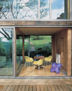 The classic yellow Robin Day chairs from Habitat perfectly complement the purple Jack light by Tom Dixon. Piers designed and built the table when he was in architecture school.
