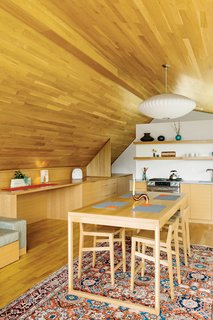 Strips of white-oak flooring line the interior of the studio, created by designer Jeff Vincent and PATH Architecture. The George Nelson Bubble Lamp Saucer pendant is available at the Dwell Store; the kitchen cabinets and appliances are by Jenn-Air. All accessories are from Canoe and Relish.