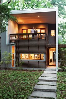 Rick and Susan Moreland survey the front yard from a terrace that’s more of an elevated front porch.
