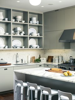 20 Dream Kitchens - Photo 10 of 20 - Custom kitchen cabinets designed by Pulltab and fabricated by Maciek Winiarczyk hold mostly vintage ironstone that Geiger has found at flea markets and estate sales over the past 20 years. "I love white," she says, "because I think food always looks better on it." She also collects vintage wooden cutting boards, shown resting against the marble tile backsplash from Stone Source.