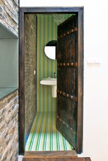 Modern Lilong House Renovation in Shanghai - Photo 3 of 11 - Carbone preserved many of the home’s original bones while replacing the roof and plumbing and shoring up the structure. The interior spaces, too, mix new and old. Allegranti found many of the furnishings and fixtures in nearby markets, including the antique doors used in his bathroom and closet.