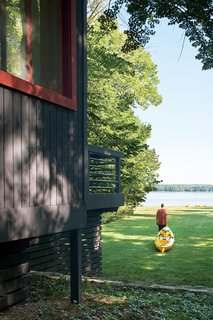 The cottage sits on an acre of mature trees, with a sloping lawn stretching to the pebbly shore of the inland lake. The Campbells regularly drag their kayaks down to the water’s edge and set off toward the deeper waters of Lake Michigan.