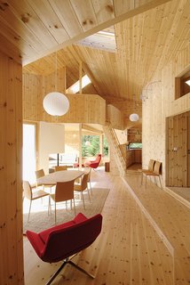 The double-height ceiling and knotty interior give the Cabin Nordmarka a pleasant lightness, despite being situated deep in the Norwegian forest. Photo by Nils Petter Dale.